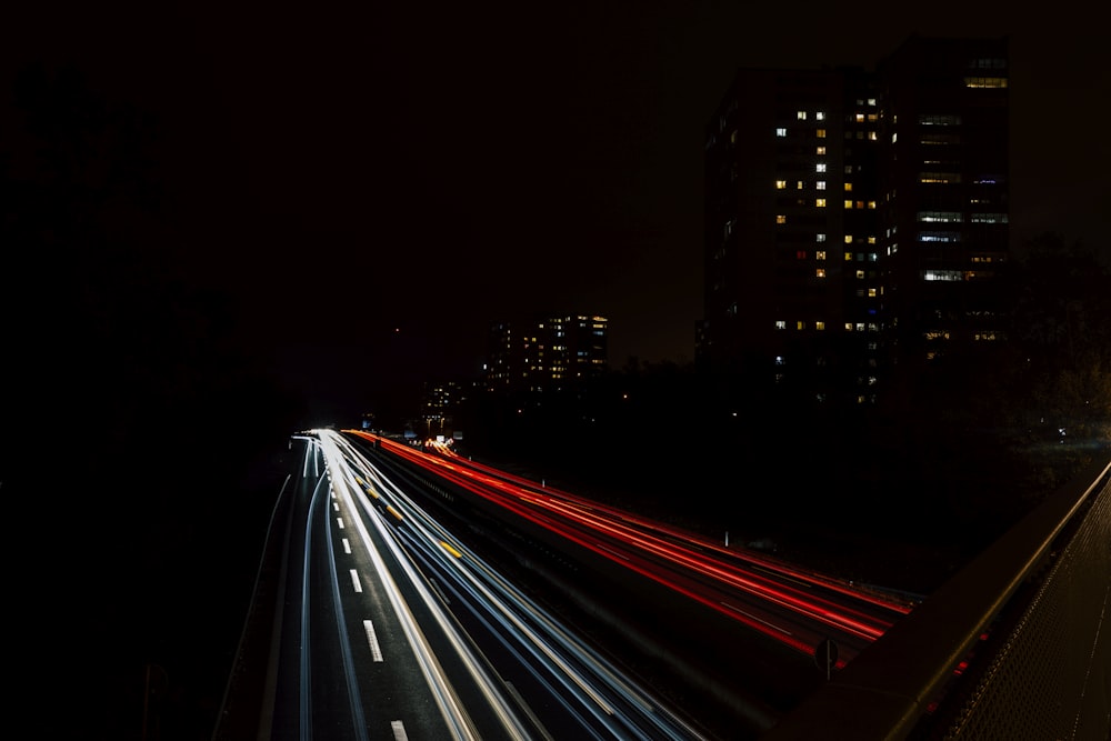 a long exposure photo of a highway at night