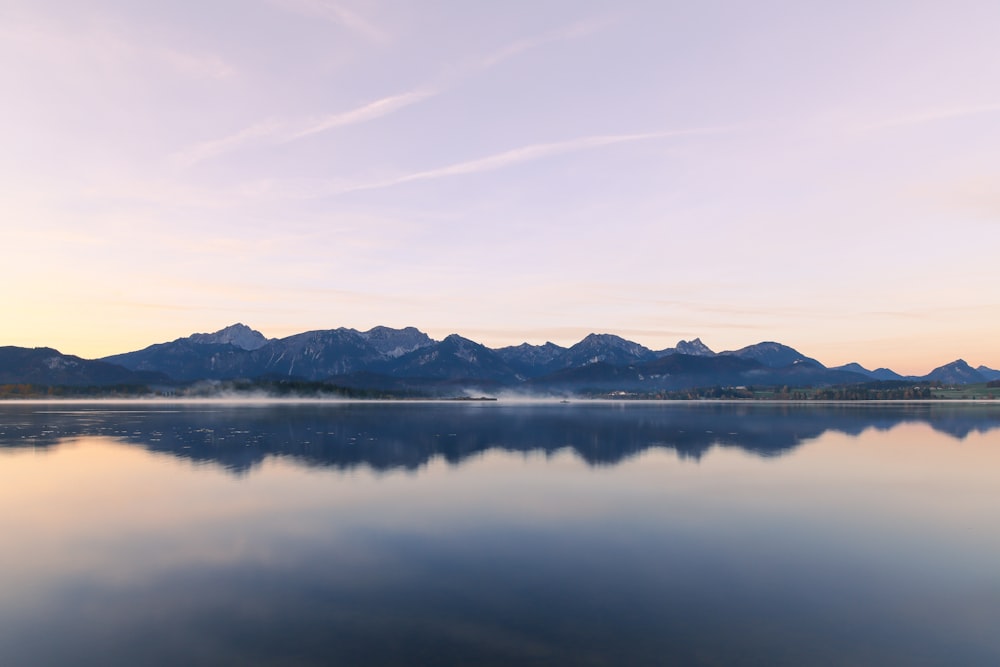 a large body of water with mountains in the background