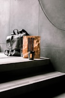A sleek Lumina Apparel backpack resting on a modern café table beside a coffee cup.