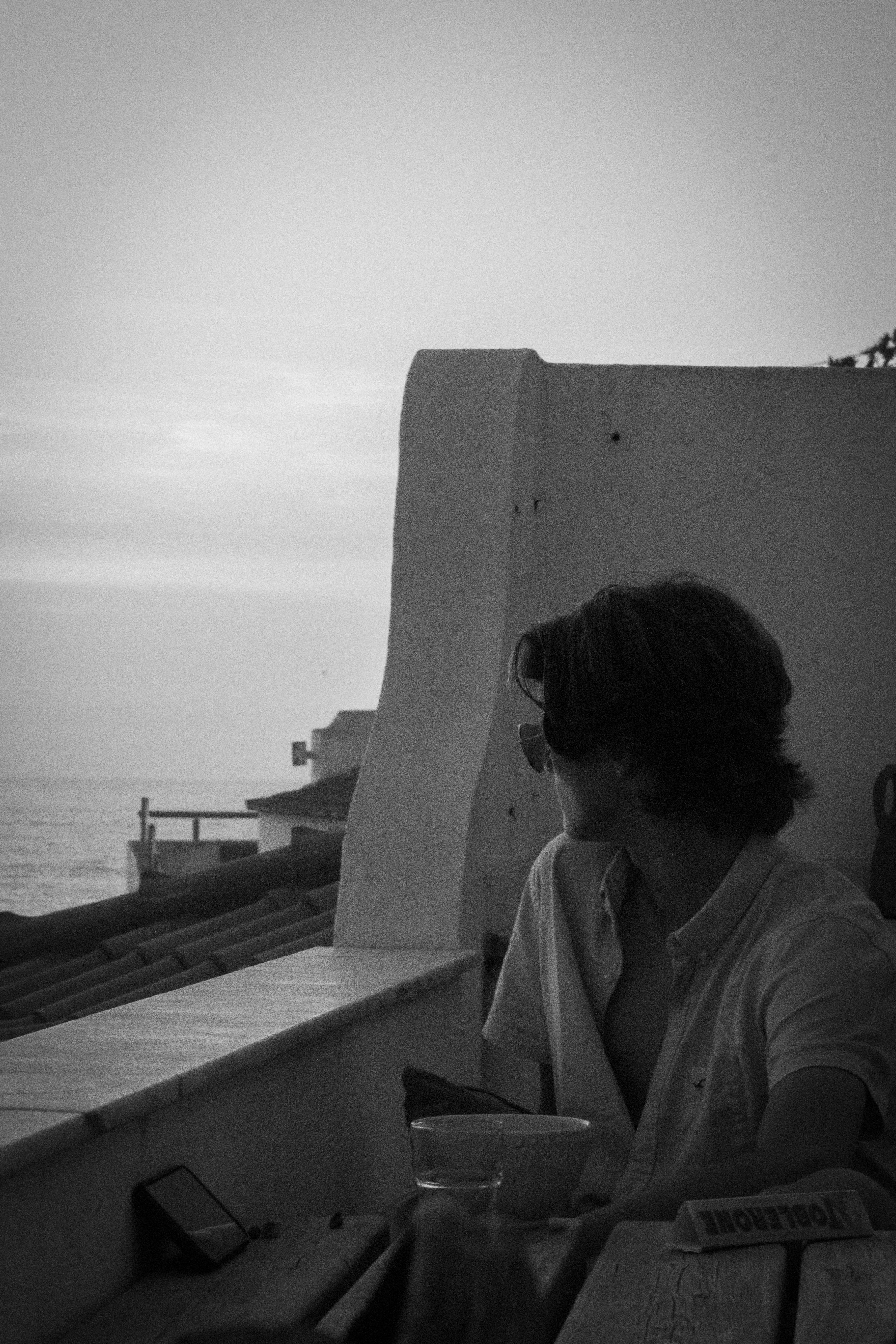a person sitting at a table with a cup of coffee
