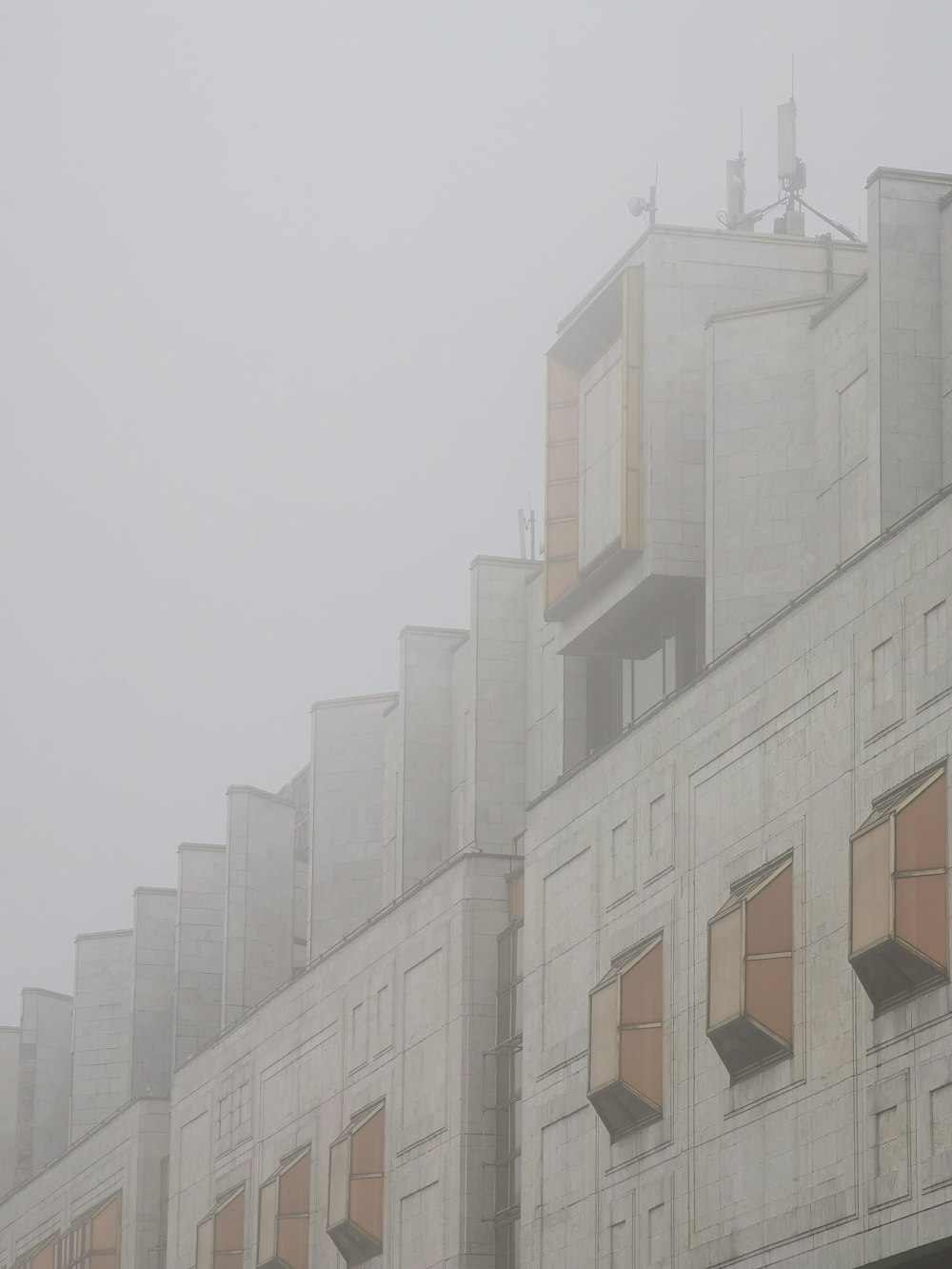 a building with many windows on a foggy day