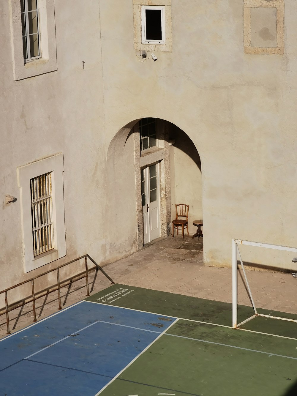 a tennis court in front of a building