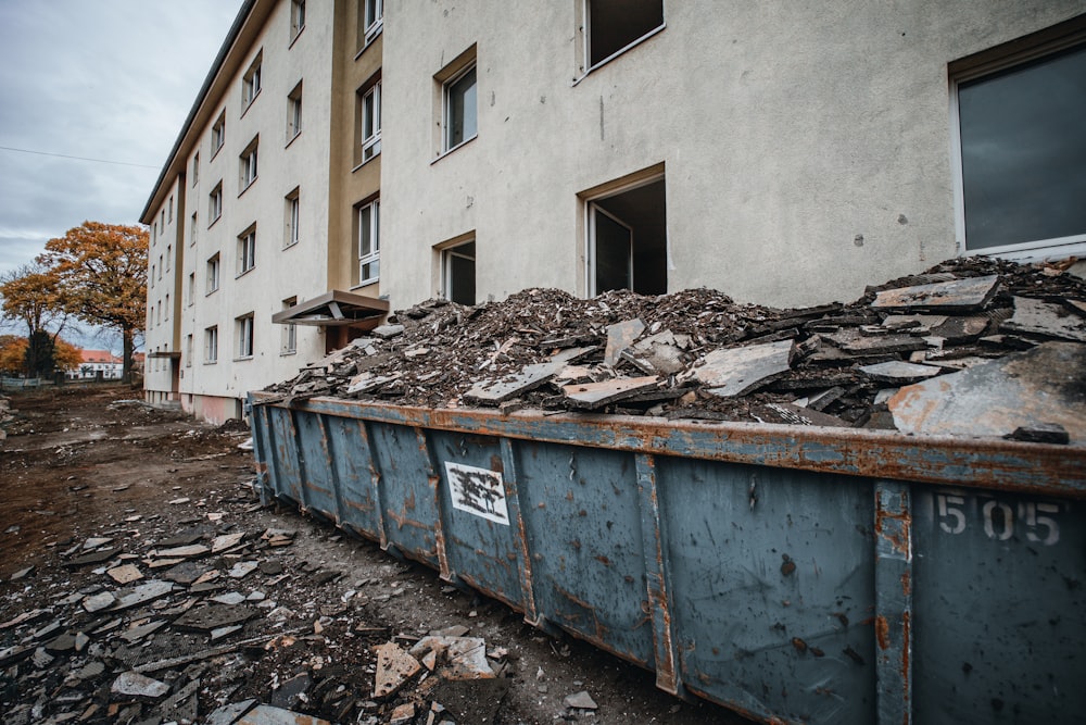 a dumpster full of rubble in front of a building