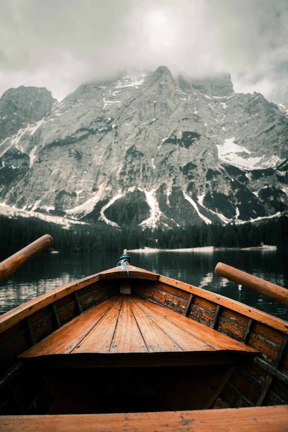 a boat on a body of water with a mountain in the background