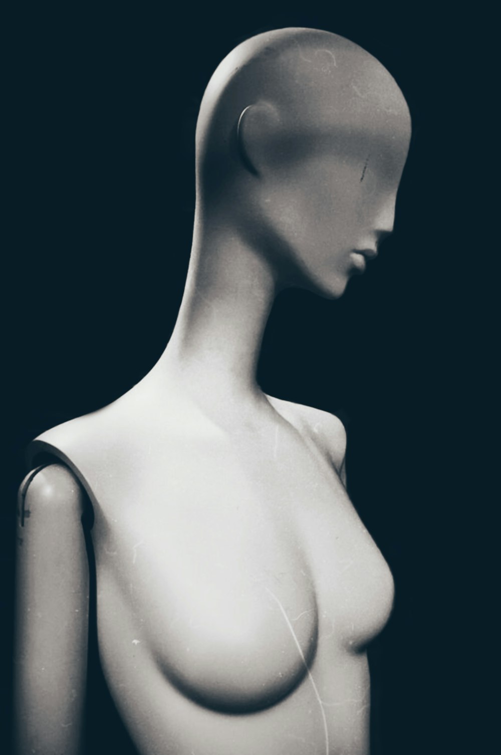 a white mannequin with a black background