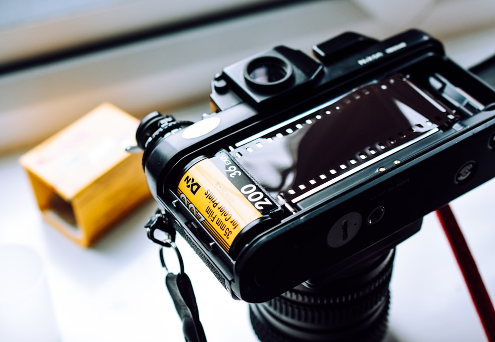 a camera sitting on top of a table next to a box