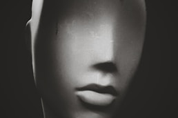 a black and white photo of a mannequin's head