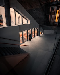 Architect standing over blueprint in modern office with city skyline view