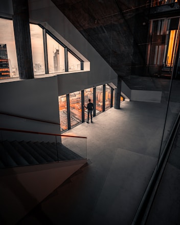 Architect standing over blueprint in modern office with city skyline view