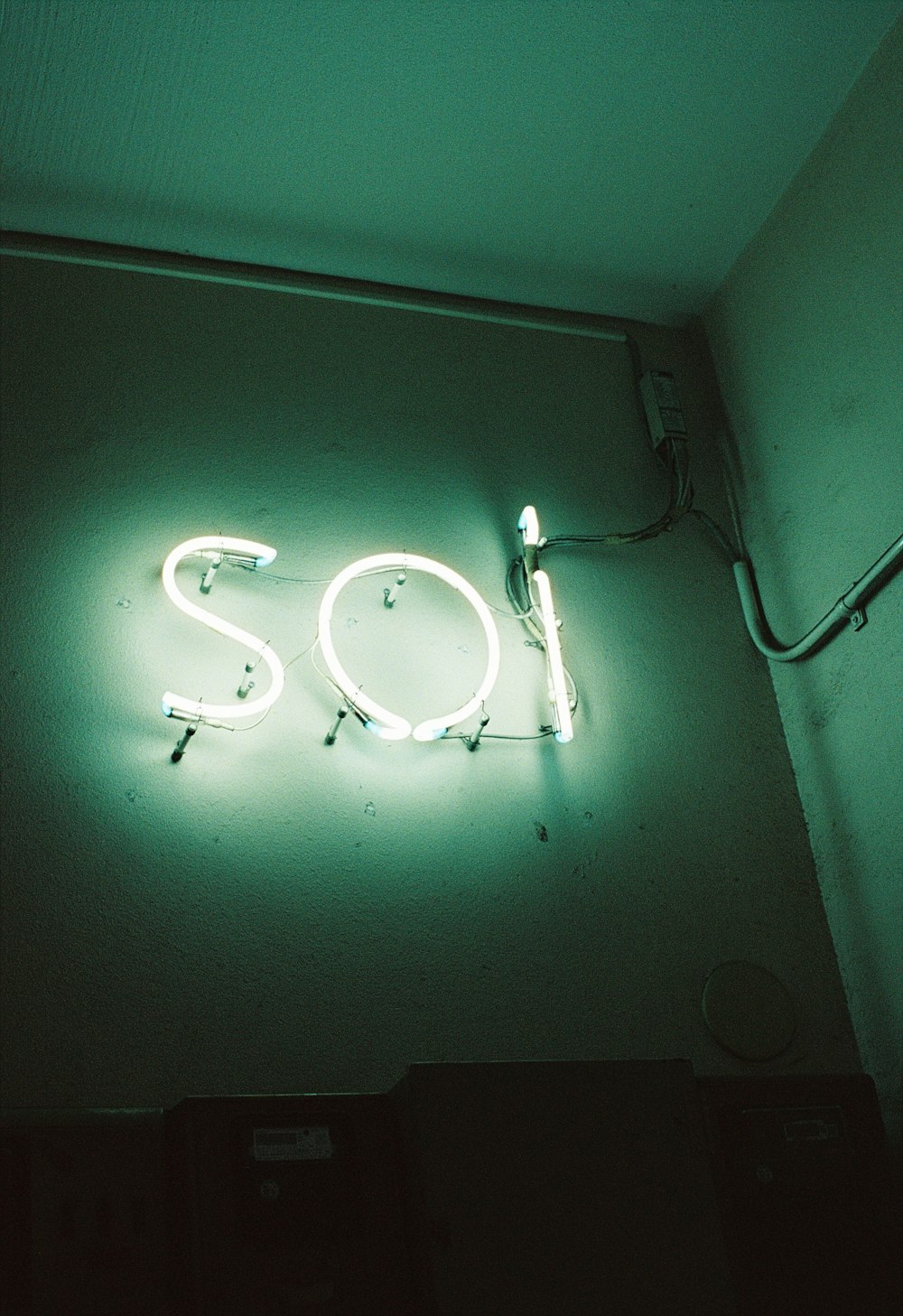 a neon sign on the wall of a room