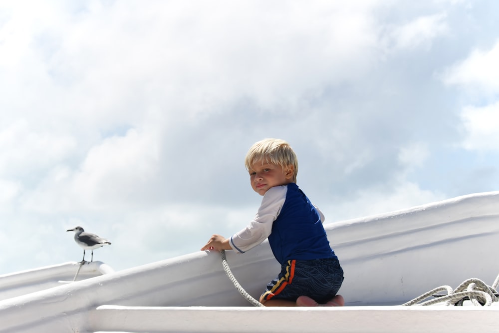 a little boy that is sitting on a boat