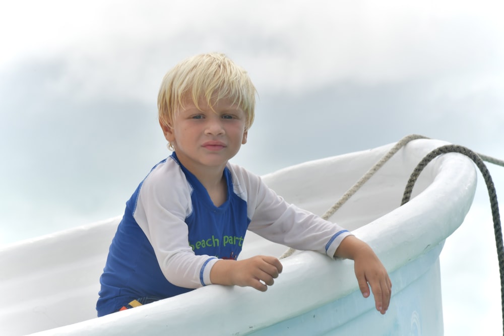 a young boy sitting in an inflatable boat