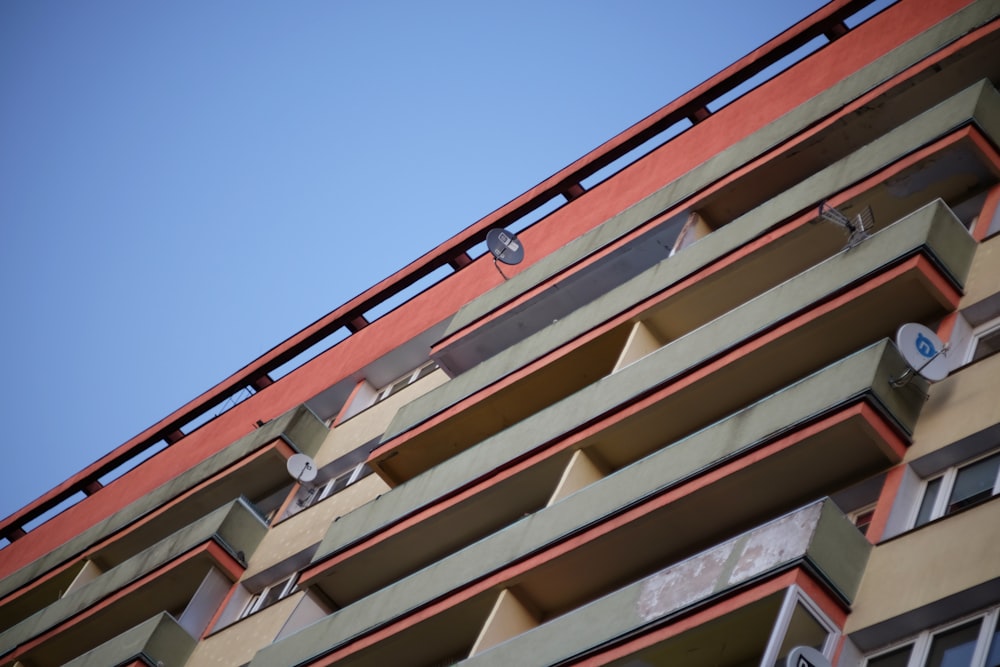 a tall building with multiple balconies and a sky background