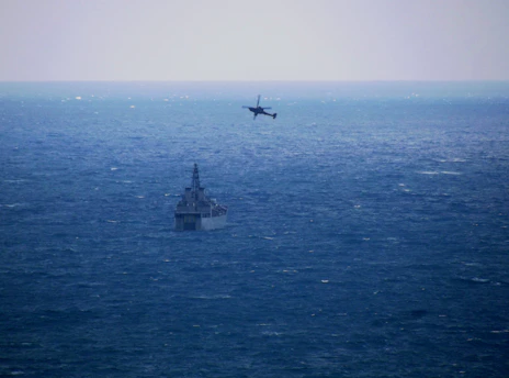 a plane flying over a large body of water