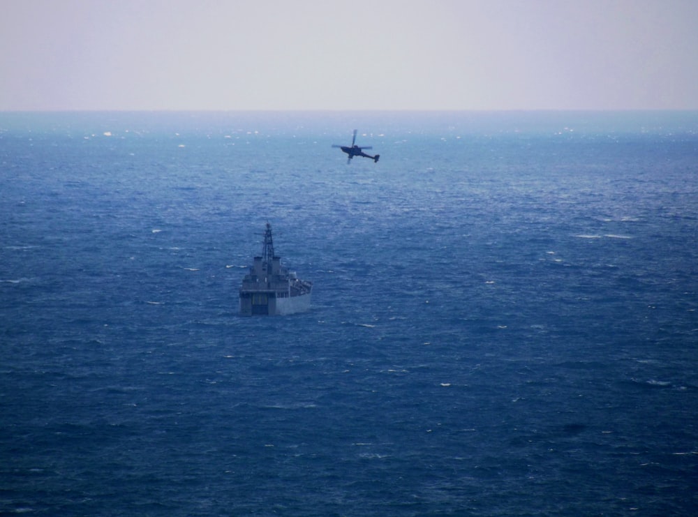 a plane flying over a large body of water