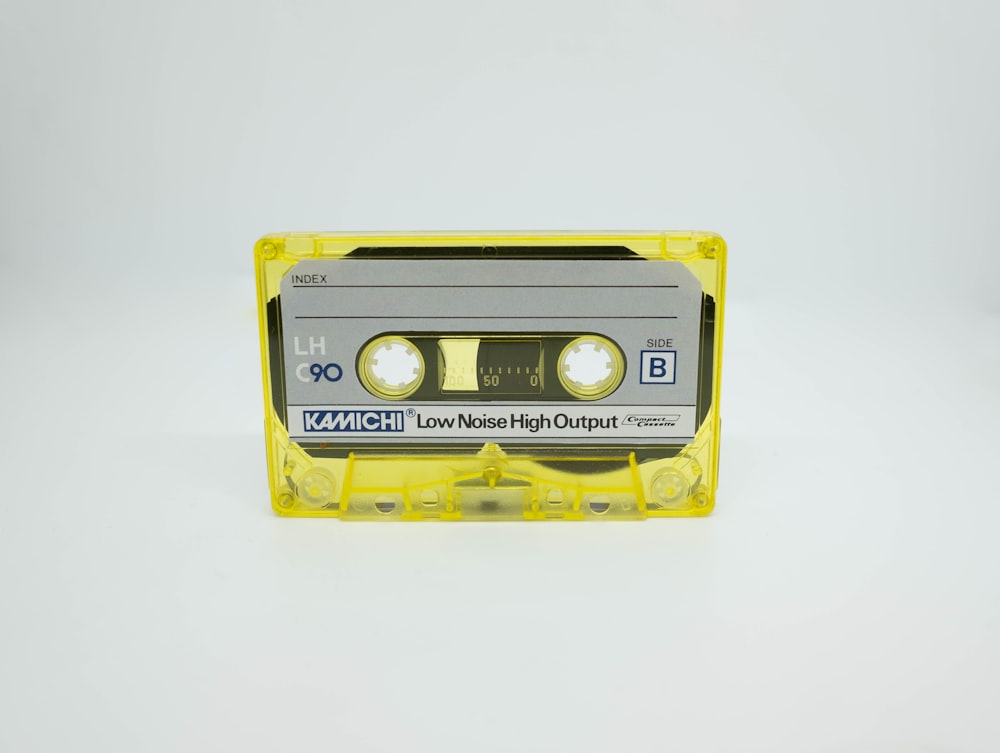 a yellow cassette tape recorder sitting on top of a white table
