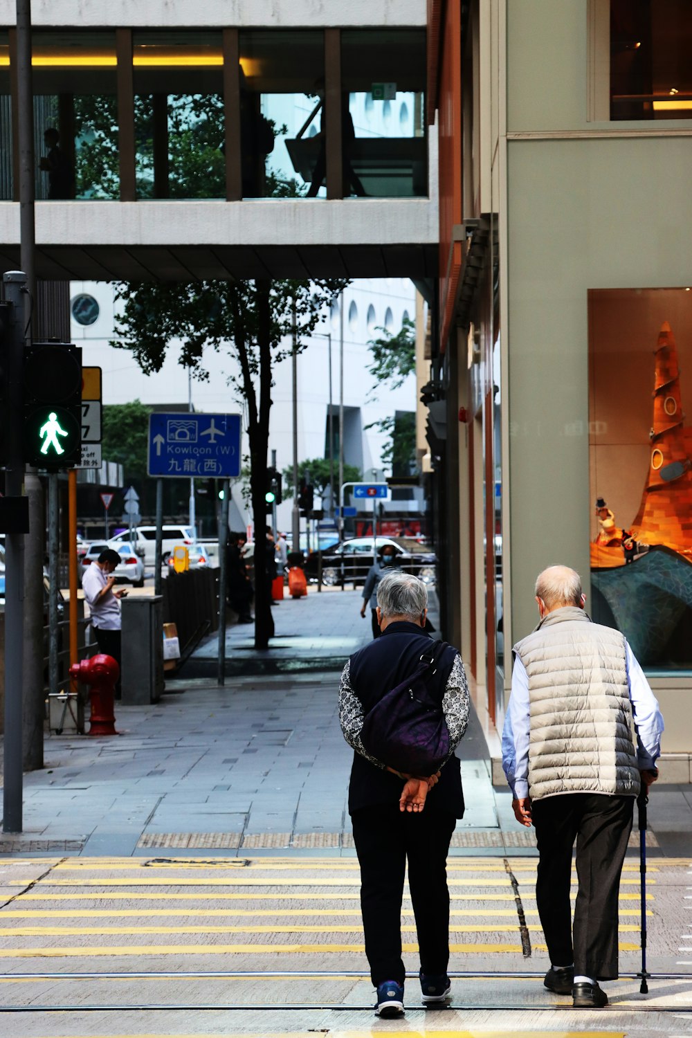 a couple of people that are walking across a street