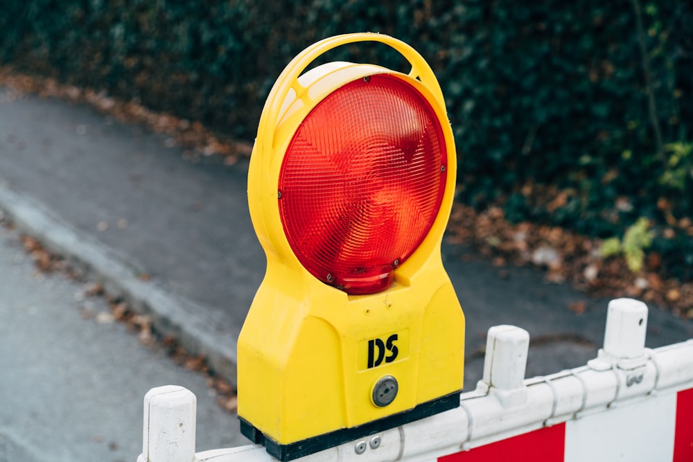 a yellow traffic light sitting on the side of a road