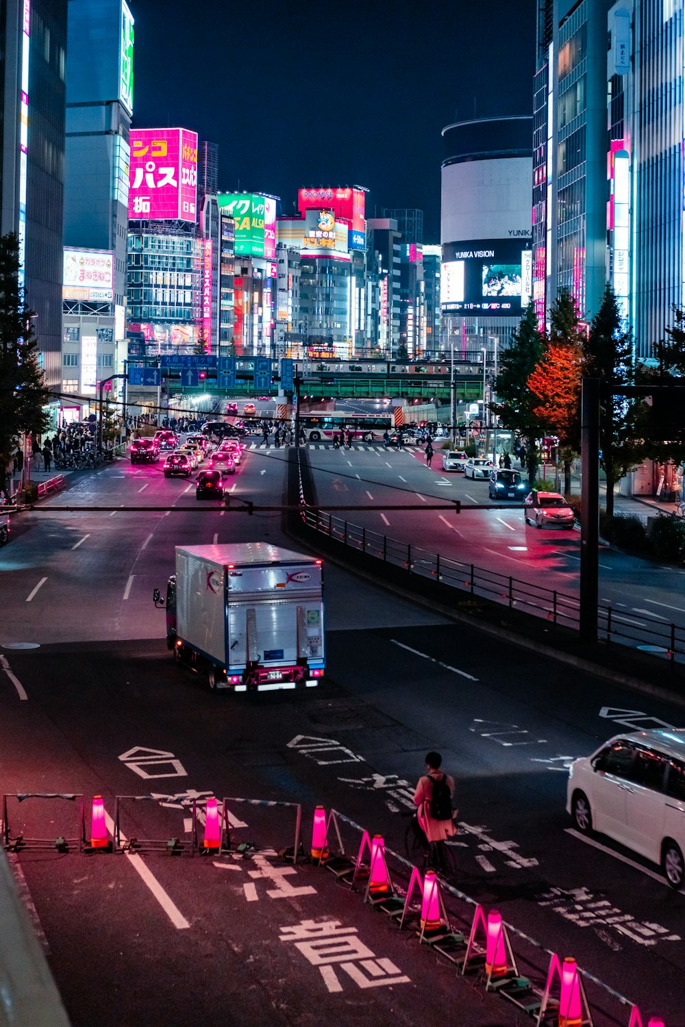 a city street at night with neon lights