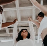 a group of people holding hands in the air