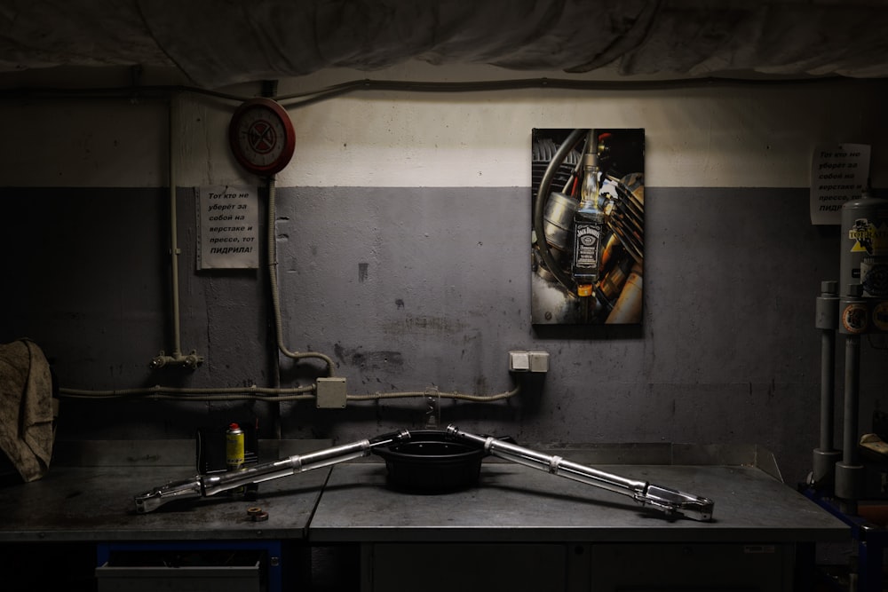 a kitchen with a sink and a painting on the wall