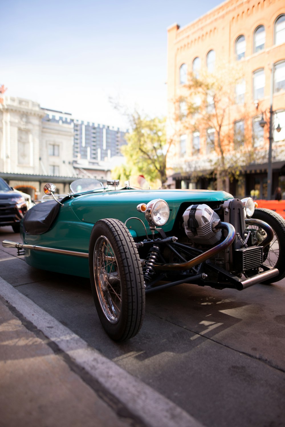 a green race car driving down a street