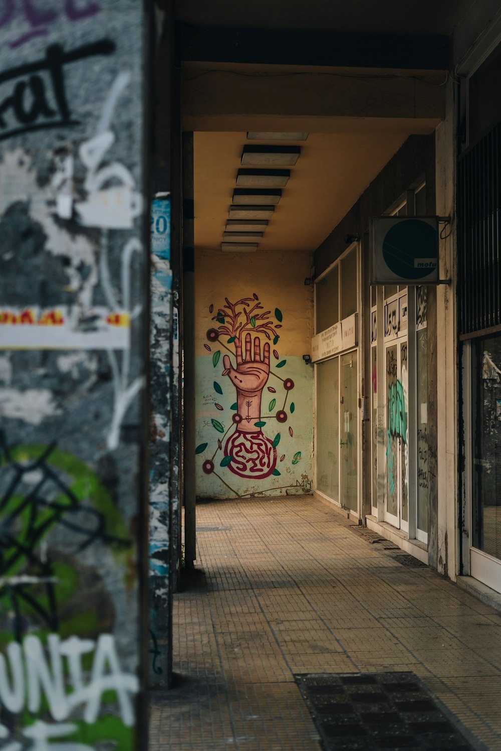 a hallway with graffiti on the walls and doors