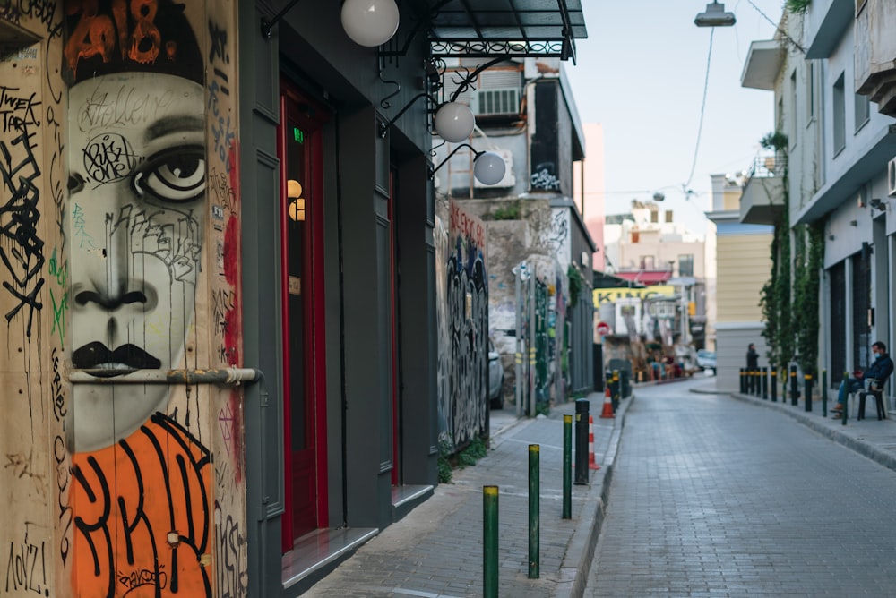 a city street with graffiti on the side of buildings