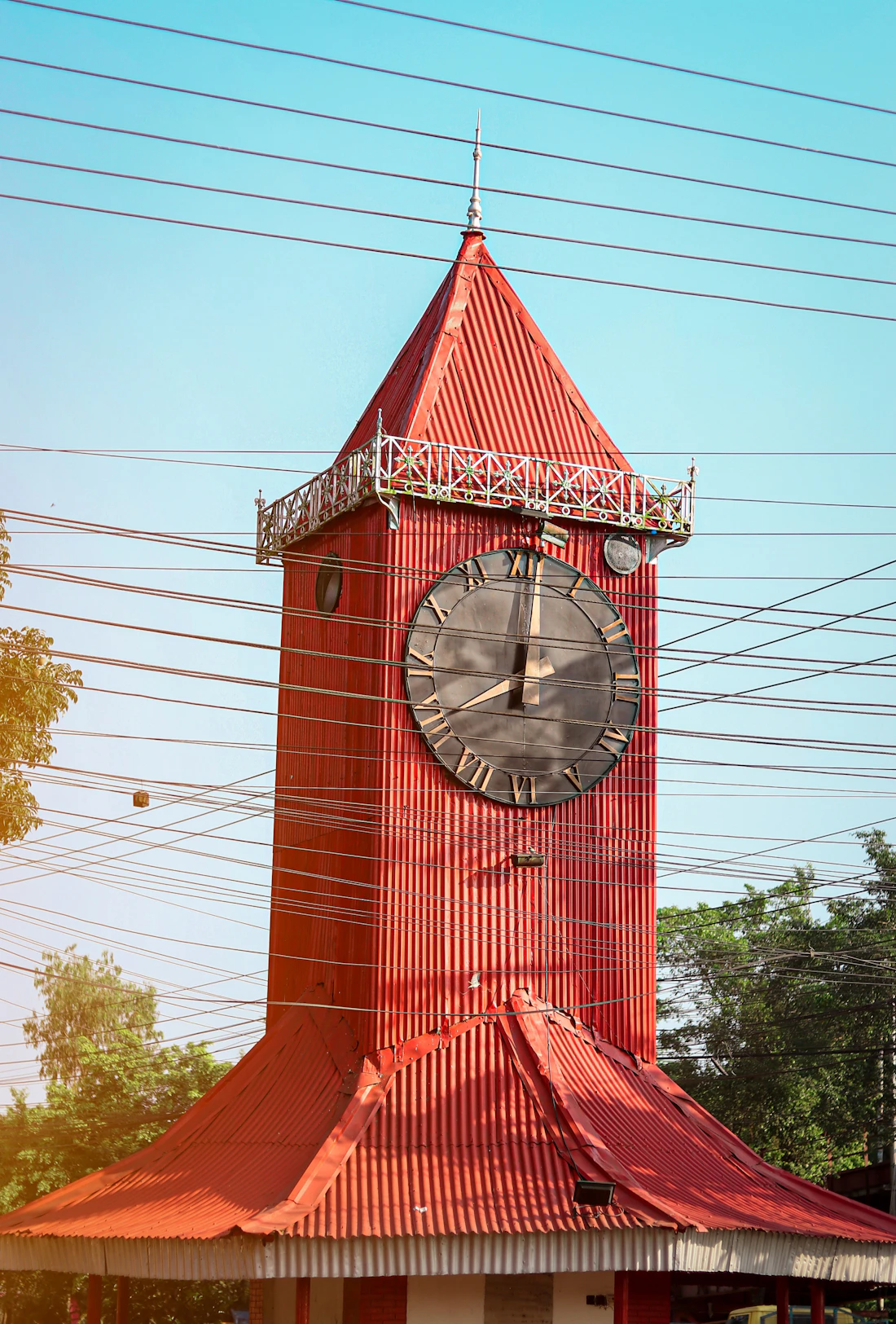 Ali Amjad's red clock tower against a blue sky