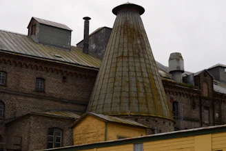 an old brick building with a large chimney
