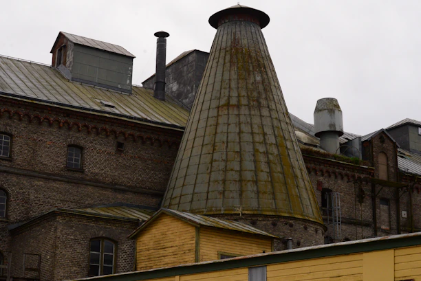 an old brick building with a large chimney