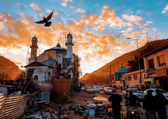 A vibrant street scene in Karachi bustling with daily life under a bright red sky.