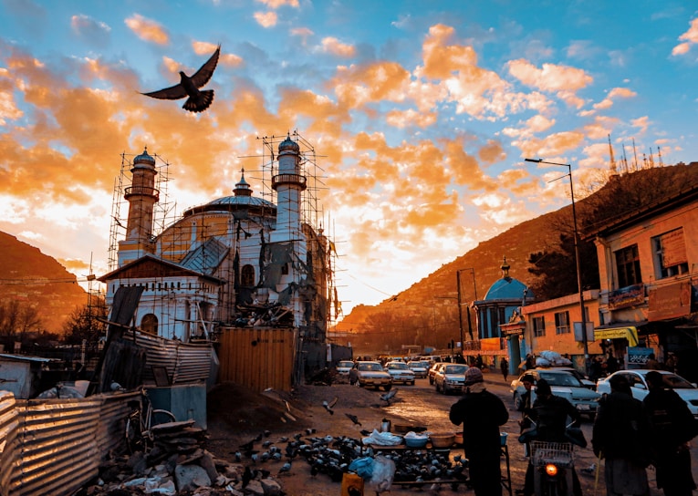 A vibrant street scene in Karachi bustling with daily life under a bright red sky.