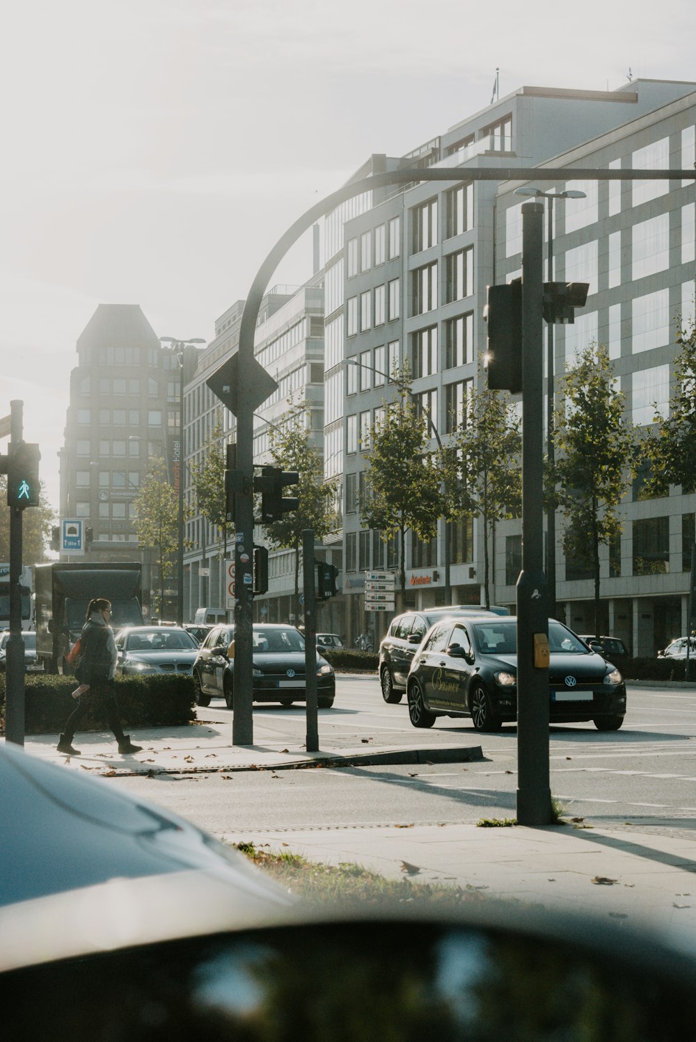 a city street filled with lots of traffic next to tall buildings