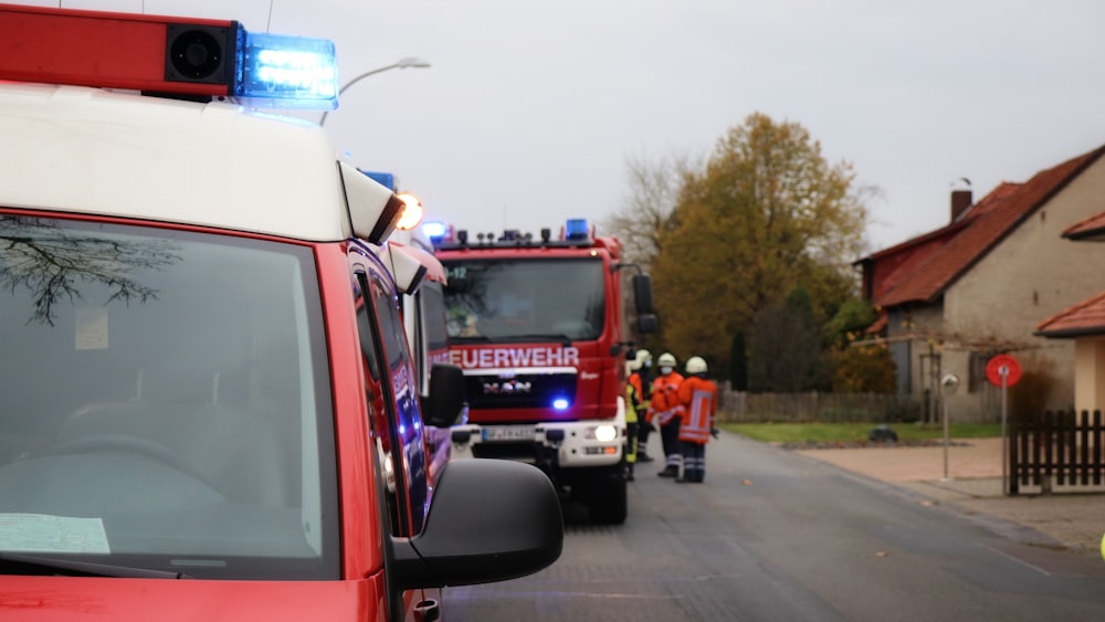 a line of fire trucks parked on the side of a road