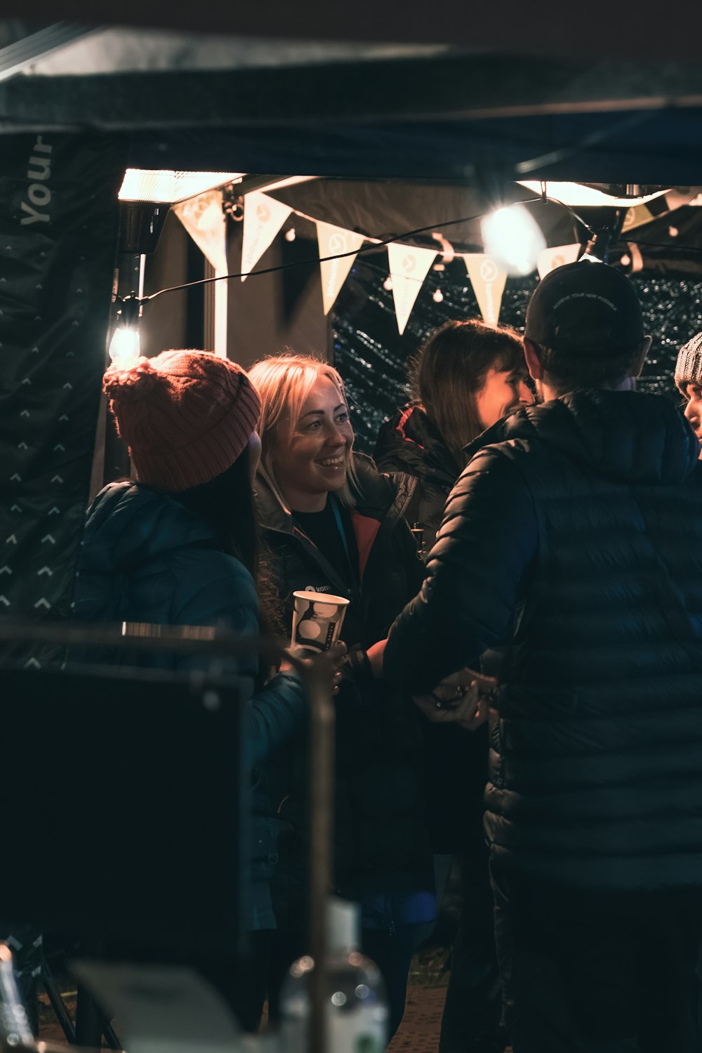 a group of people standing around each other