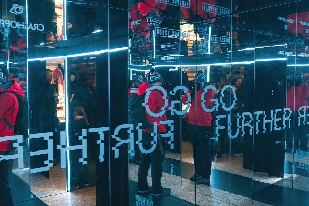 a group of people standing in front of a mirror