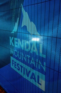 A medieval-style banner with intricate knotwork framing the festival sponsors' logos.