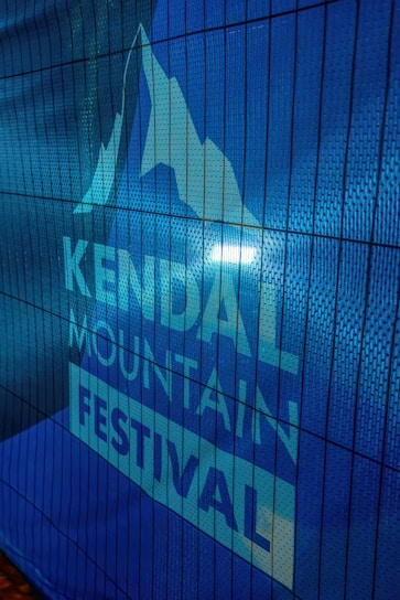 A medieval-style banner with intricate knotwork framing the festival sponsors' logos.