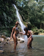 a group of people standing in a river
