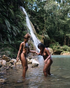 a group of people standing in a river