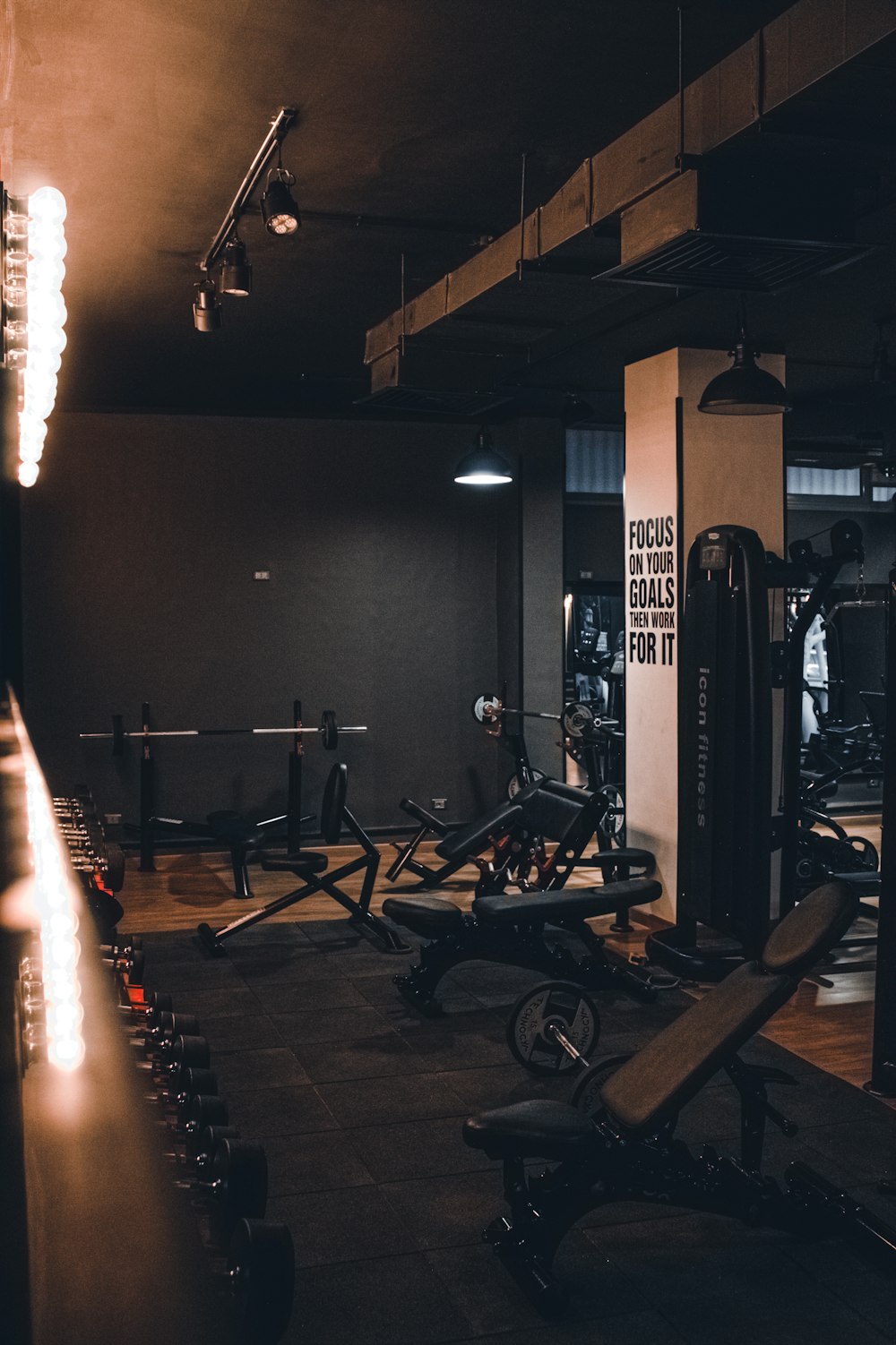 a gym with a row of exercise machines