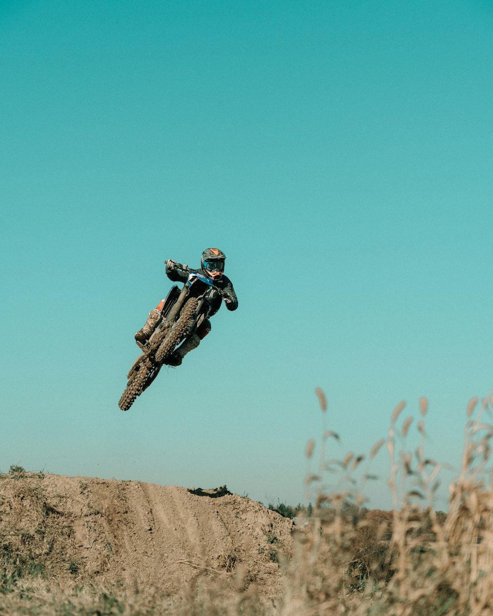 a man riding a dirt bike through the air