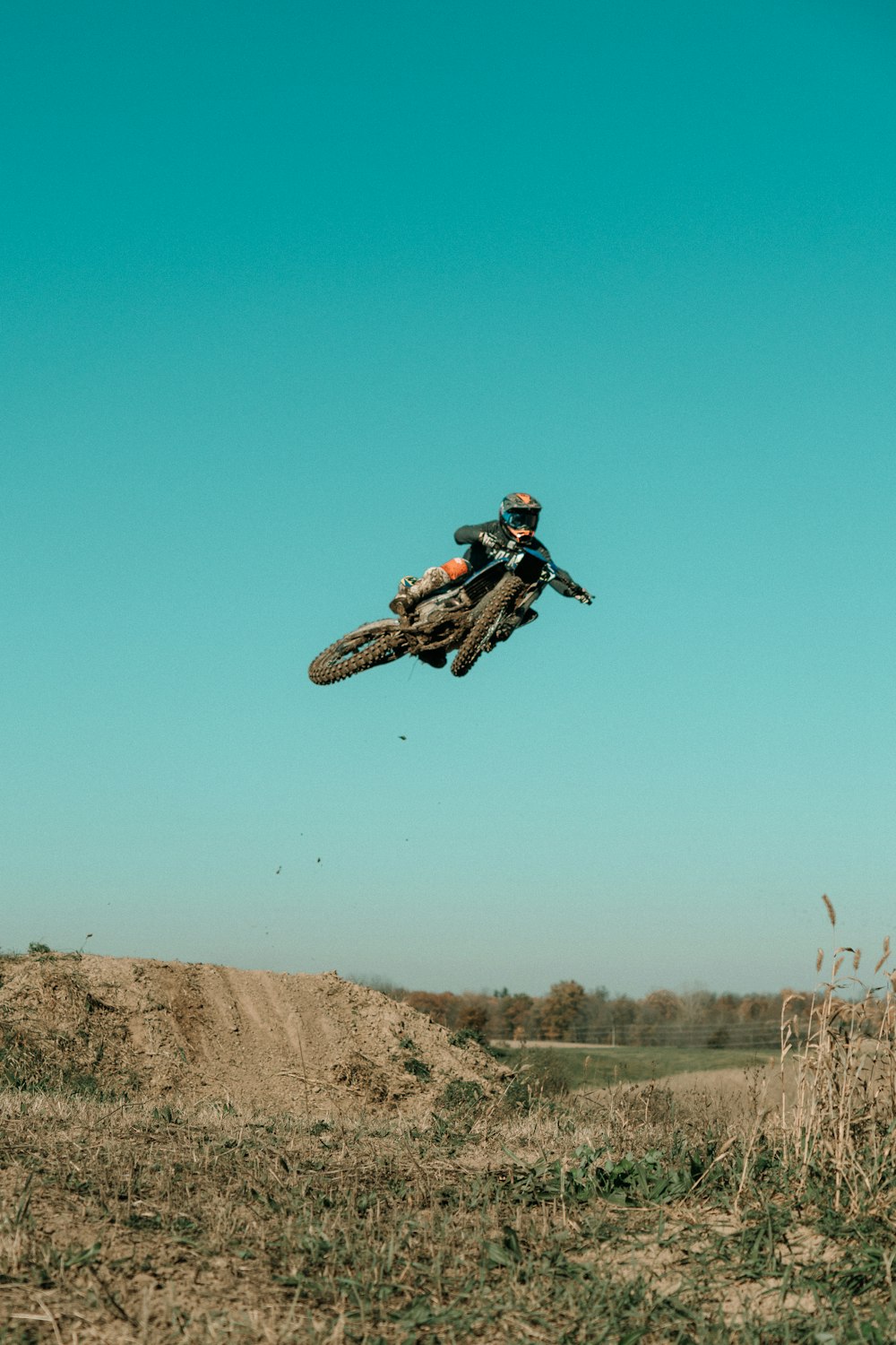 a person jumping a dirt bike in the air
