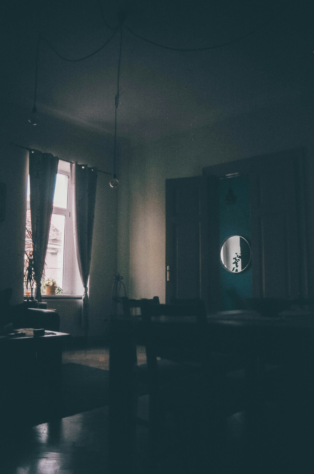 a dimly lit room with a large window