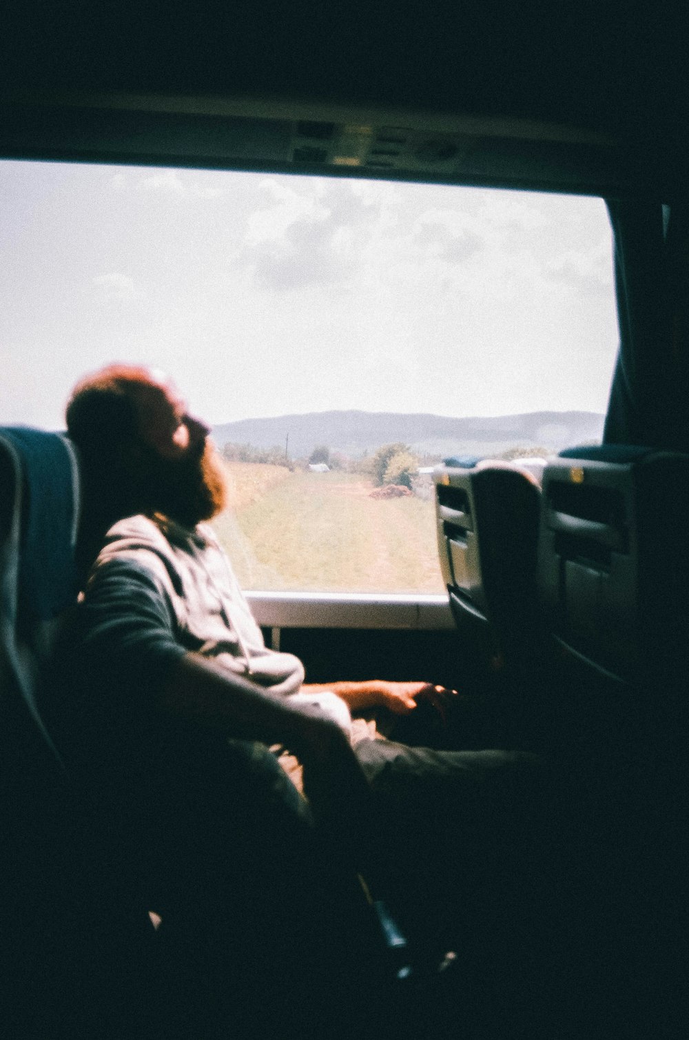 a man sitting in a truck looking out the window