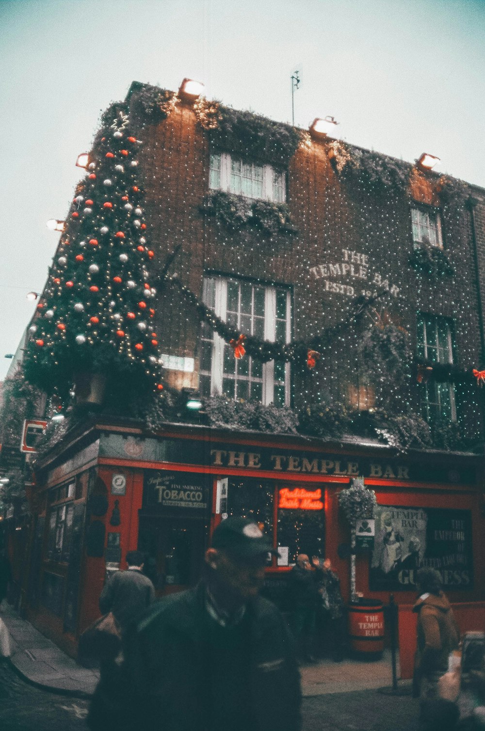 a tall building with a christmas tree on top of it