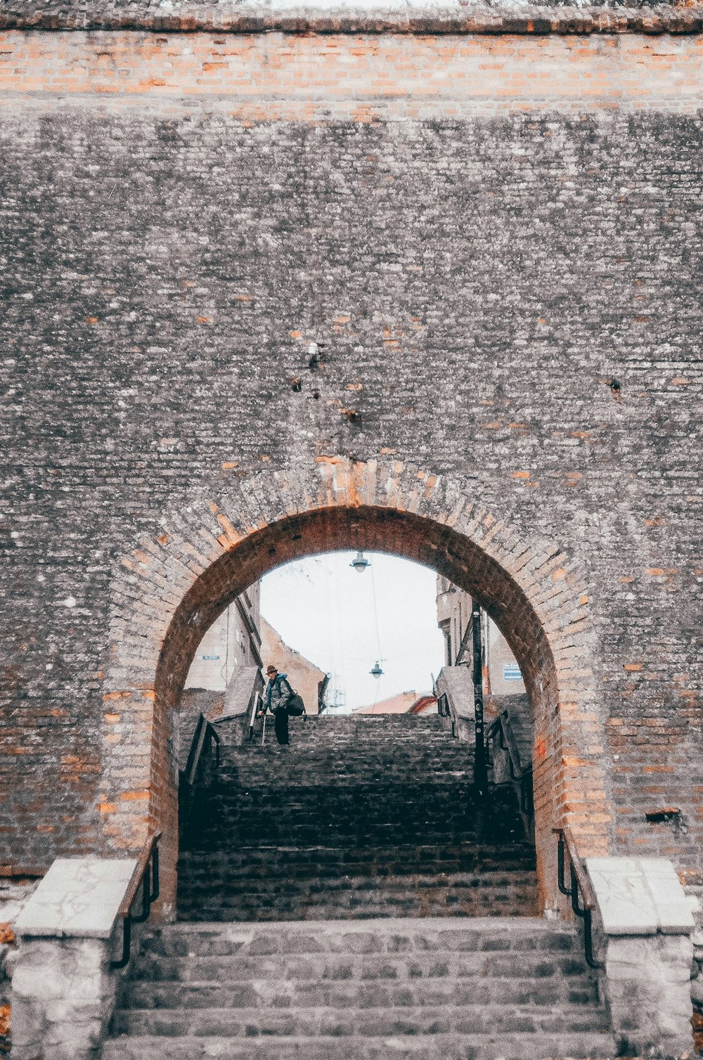 a brick wall with stairs leading up to it