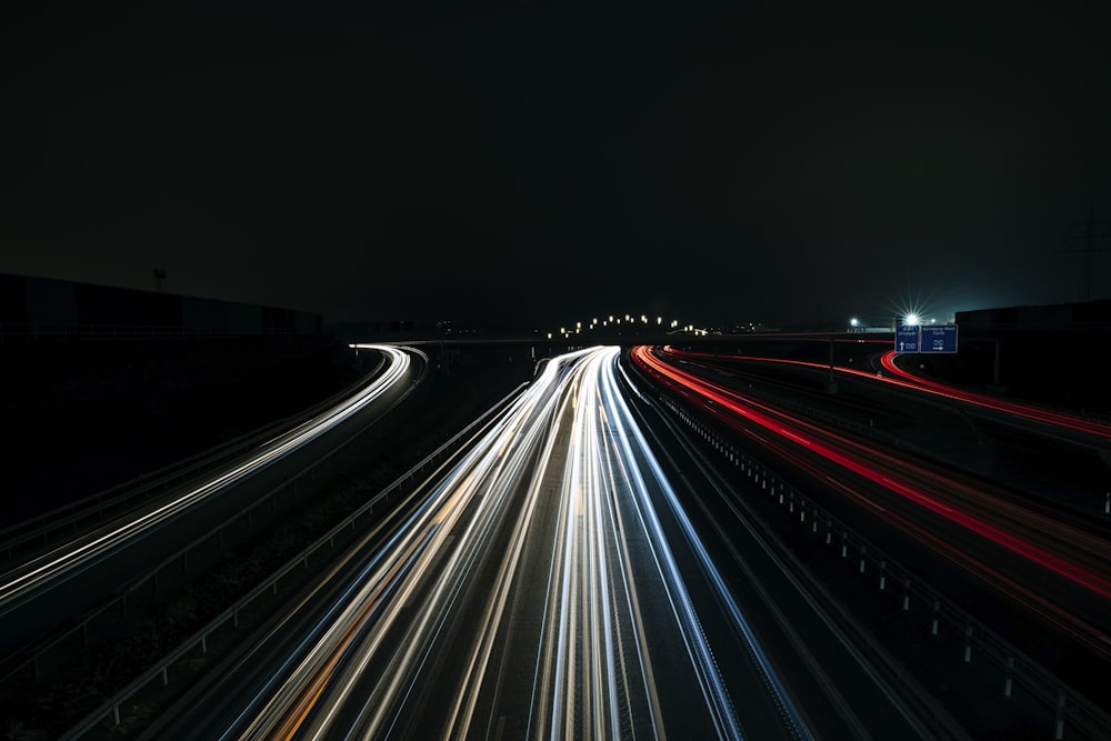 a long exposure photo of a highway at night