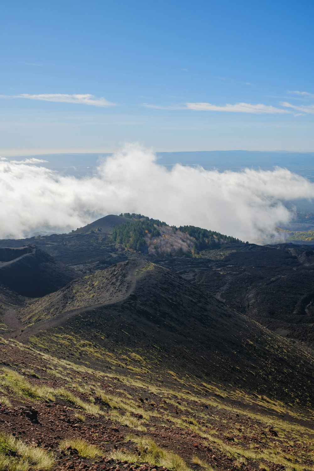 a view of a mountain range with clouds in the distance